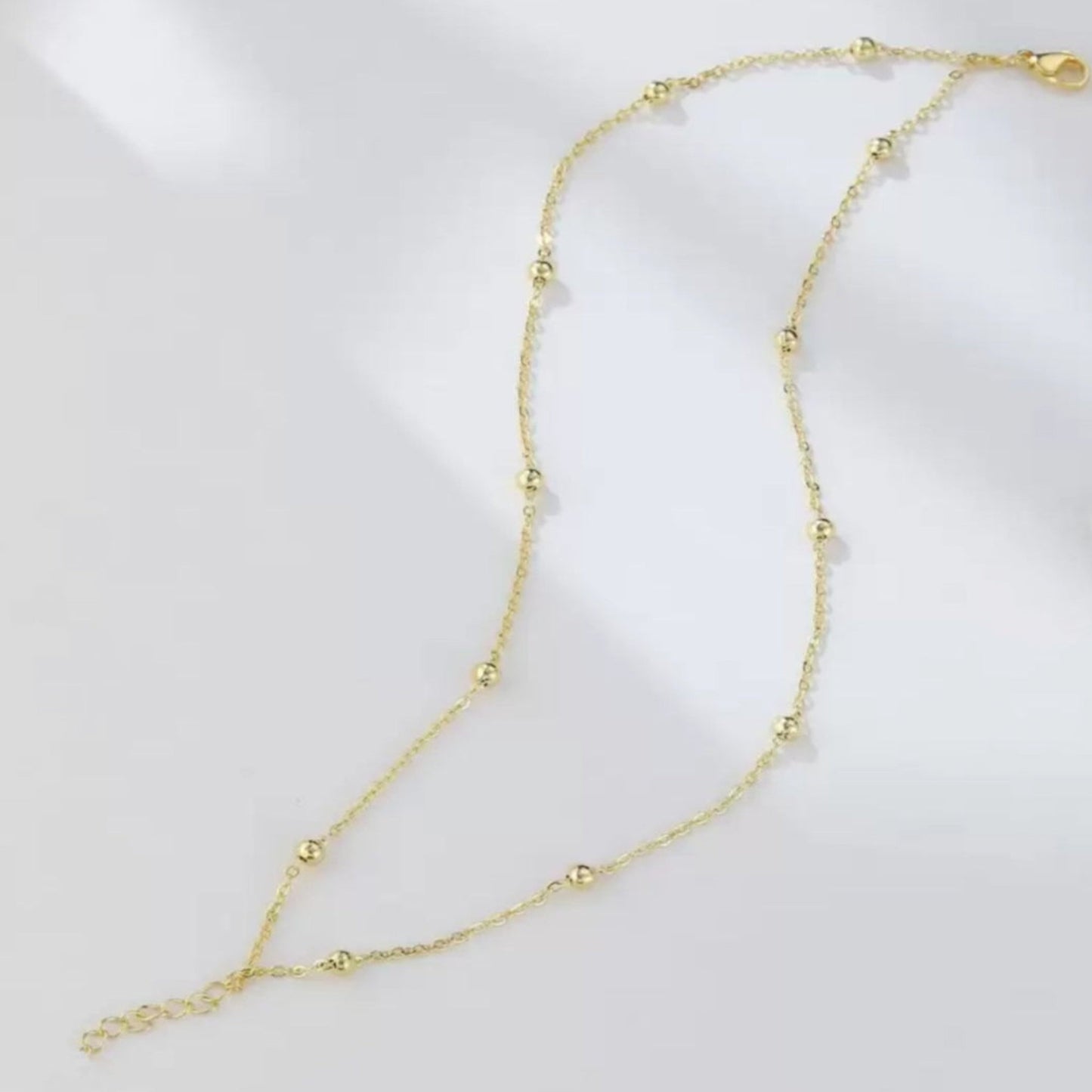 Gold necklace on a white background