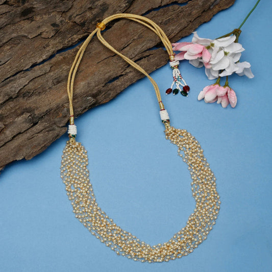 Beaded necklace with floral accents on a blue background