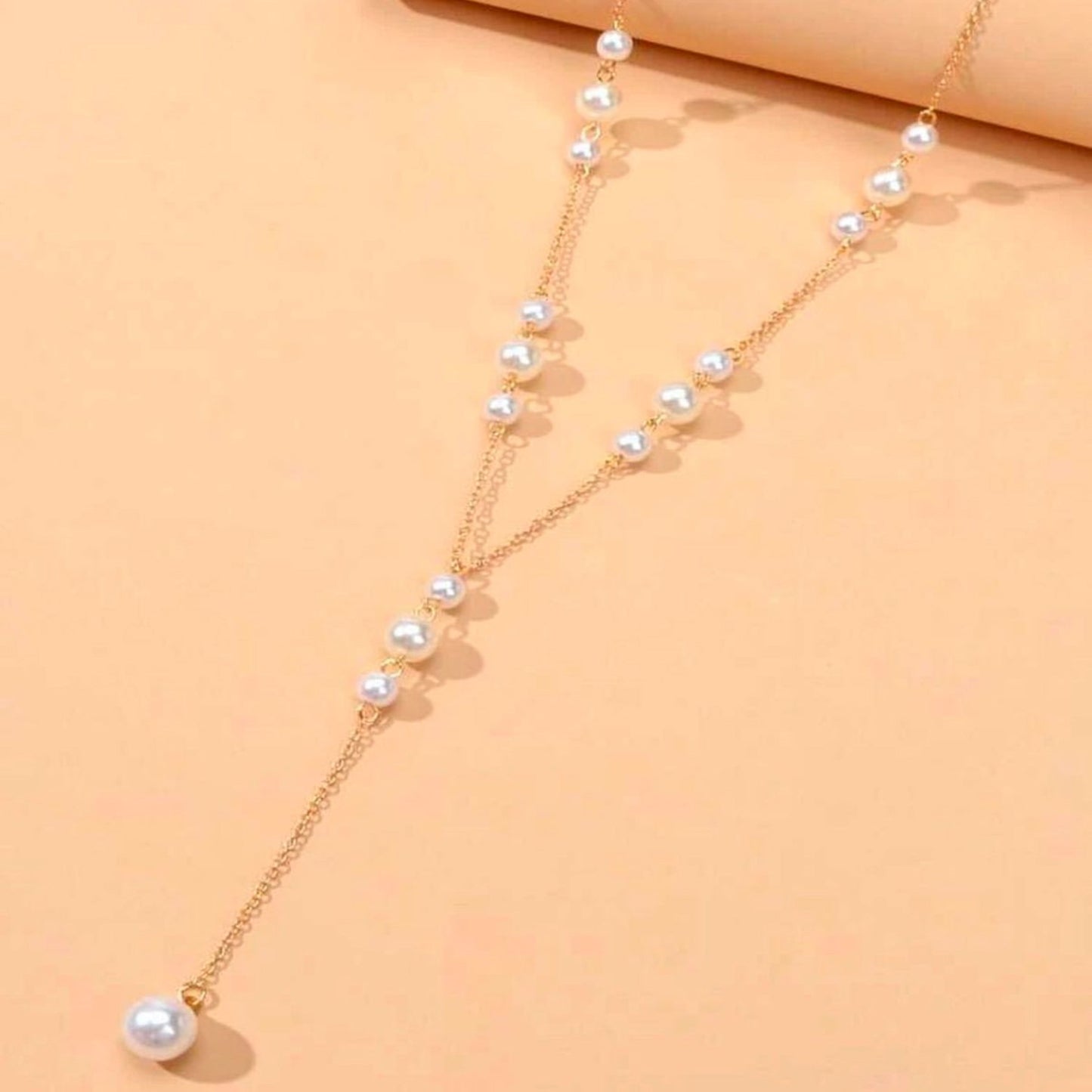 Pearl necklace on a beige background