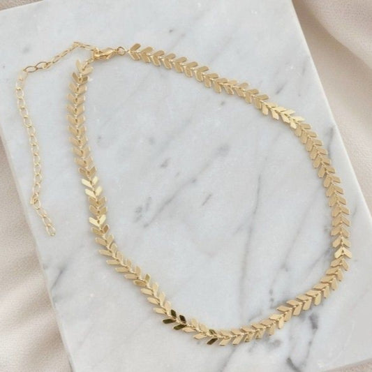 Gold necklace on a marble surface