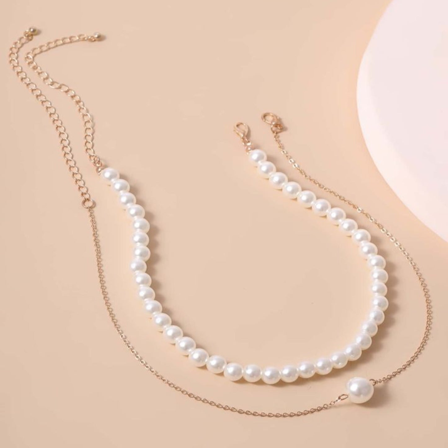 Pearl necklace on a beige background