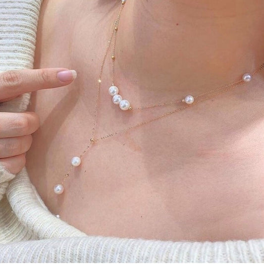 Pearl necklace on a person's neck with a blurred background