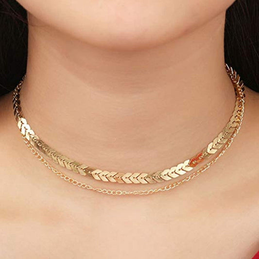 A gold double-layer choker necklace worn around the neck, displaying a polished, reflective finish.