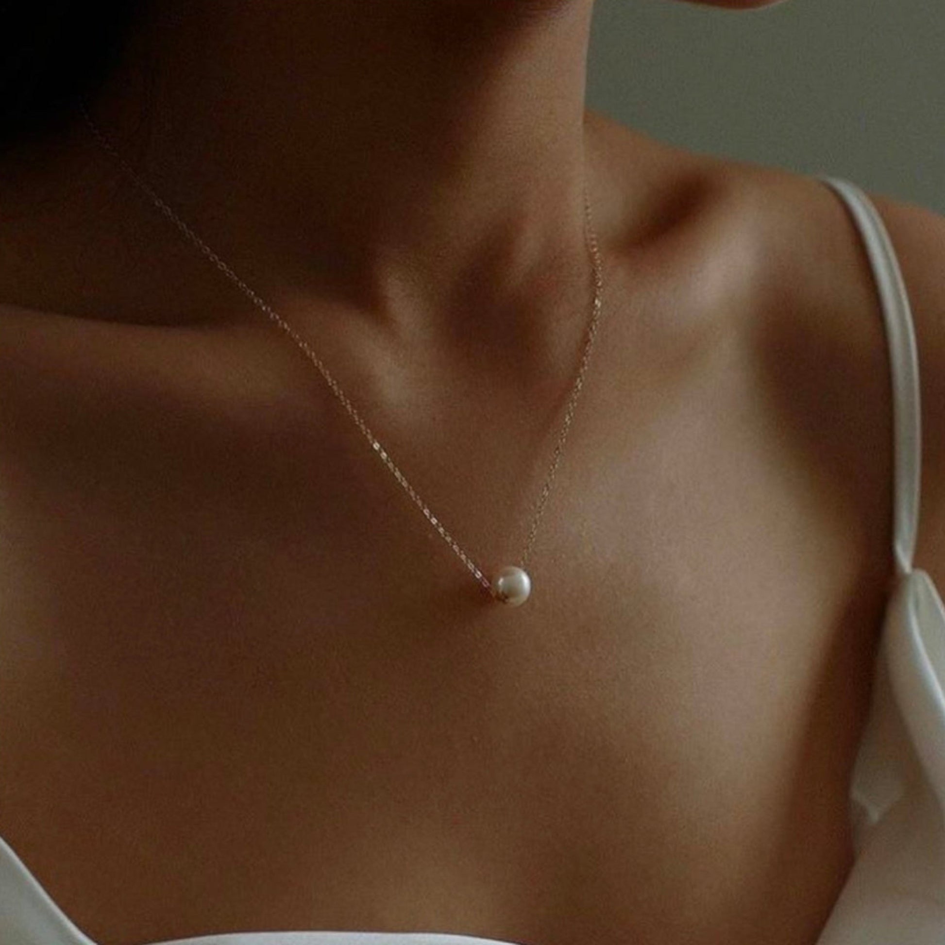 Woman wearing a delicate pearl necklace.