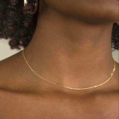Gold necklace on a person's neck