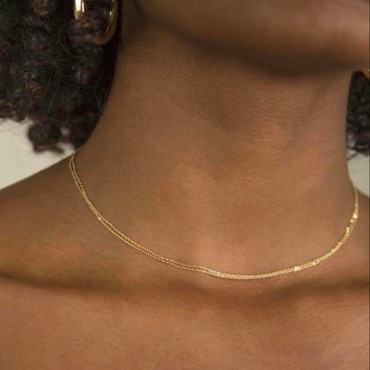 Gold necklace on a person's neck