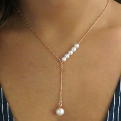 Pearl necklace with gold chain on a person's neck