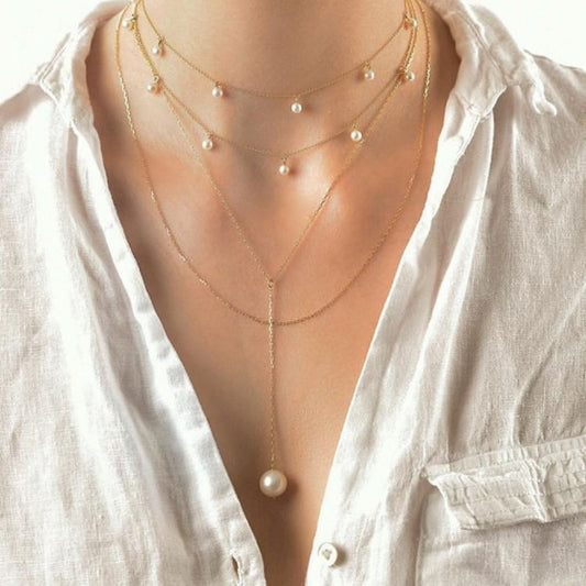 Pearl necklace layered with a white shirt
