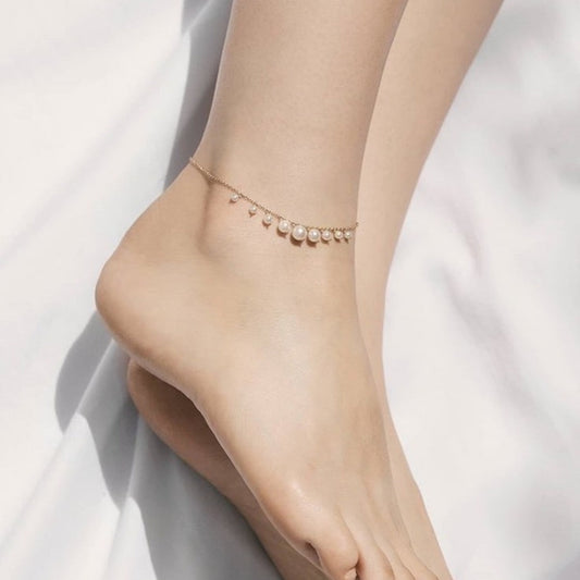 Ankle bracelet with pearls on a white background