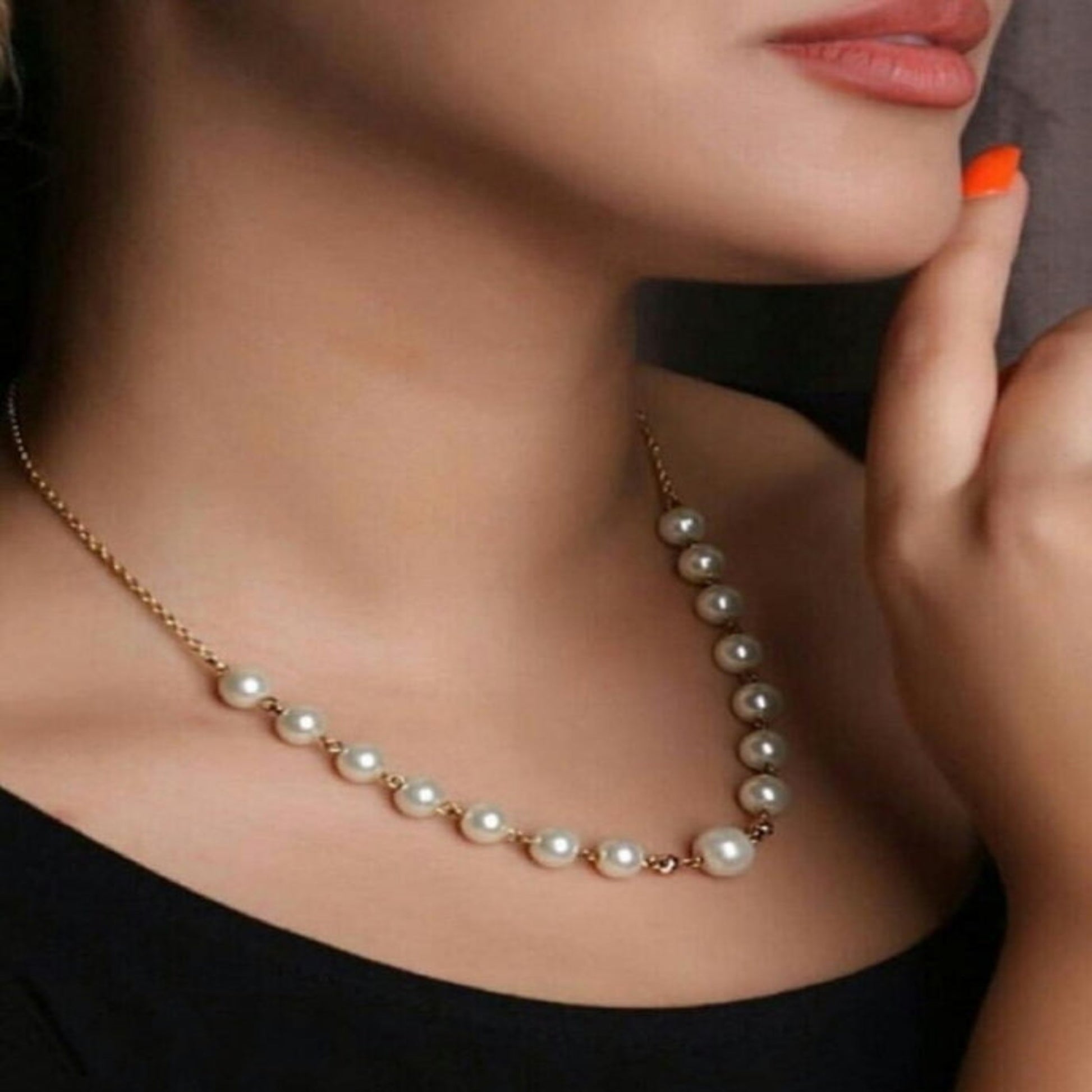 Pearl necklace worn by a model with a blurred background