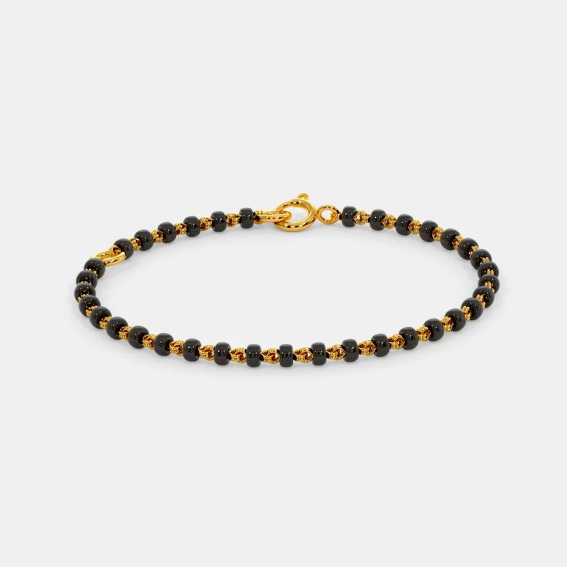 Black beaded bracelet with gold clasp on a white background