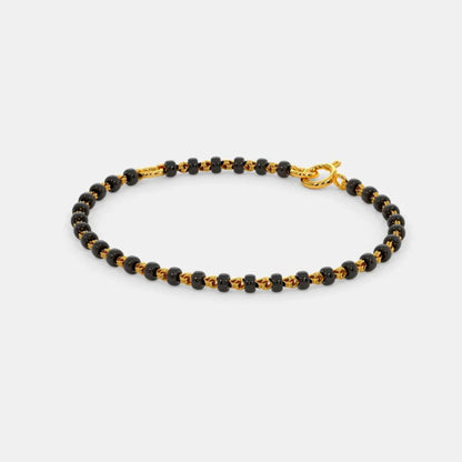 Black and gold beaded bracelet on a white background