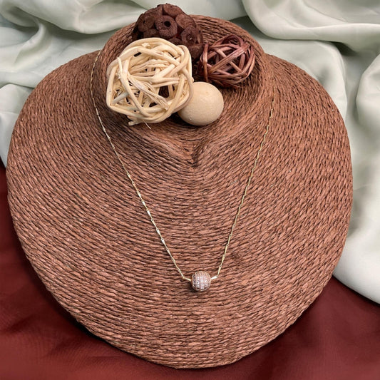 Brown woven basket with decorative items and a necklace on a white fabric background