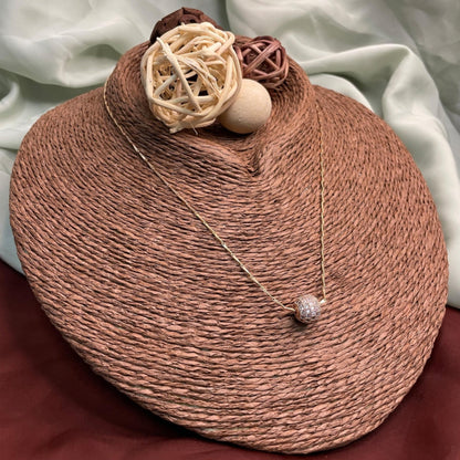 Woven basket with decorative elements on a soft fabric background
