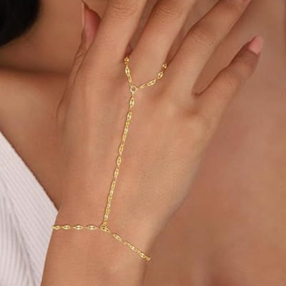 Gold body chain worn on a hand with a blurred background