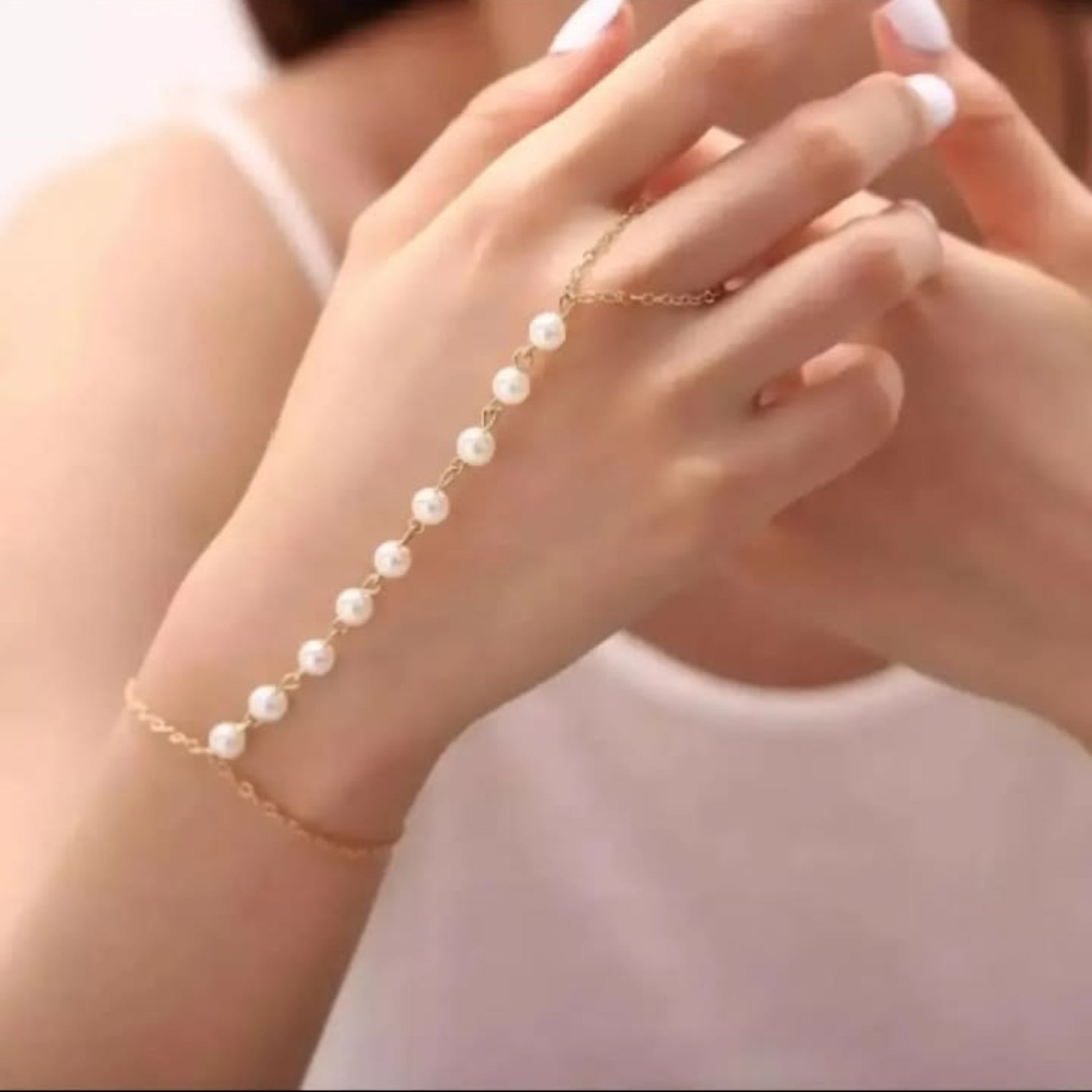 Pearl bracelet on a person's wrist with a soft background